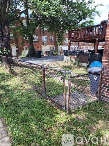 A fenced area with a blue ball in the corner.