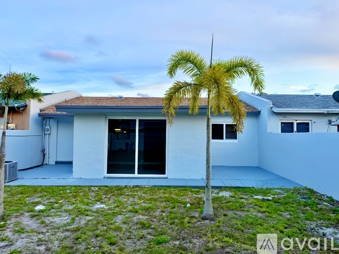 A house with a palm tree in front of it.