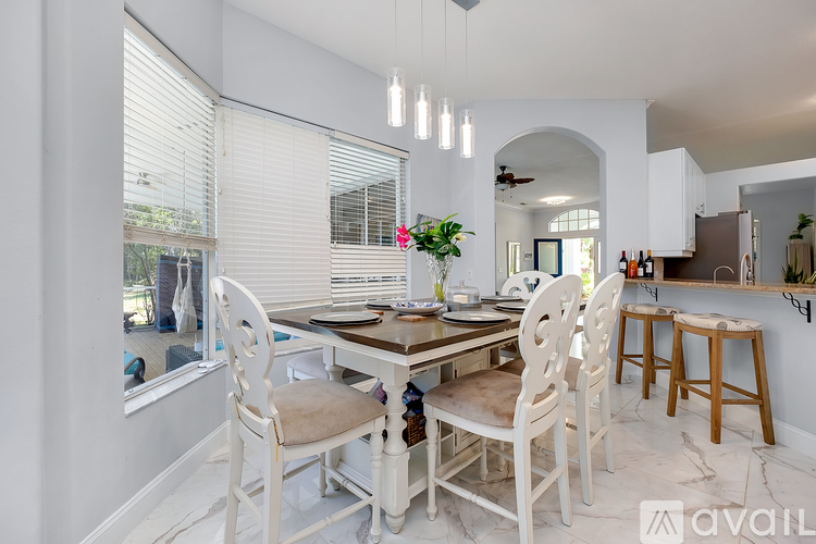 A dining room with a table set for four.