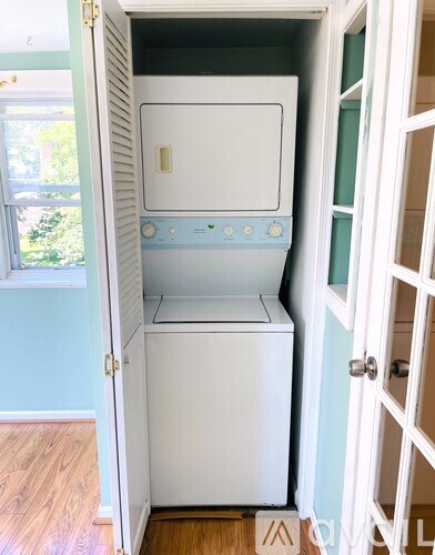 A white dishwasher and oven in a kitchen.