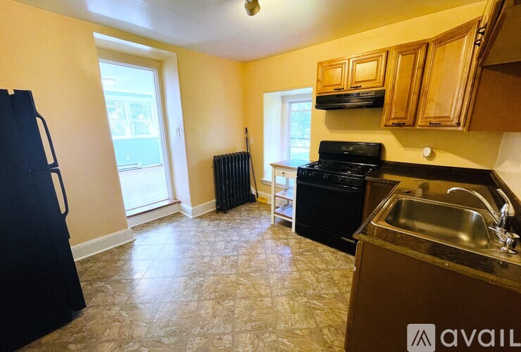A kitchen with a black fridge, black stove, and a black dishwasher.