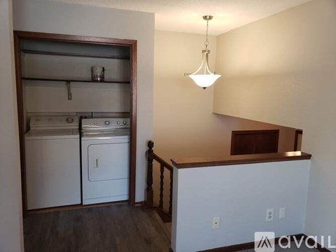 A kitchen with a white dishwasher and a white refrigerator.