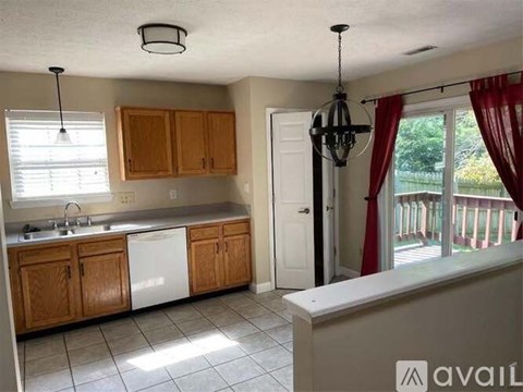 A kitchen with wooden cabinets and a white dishwasher.
