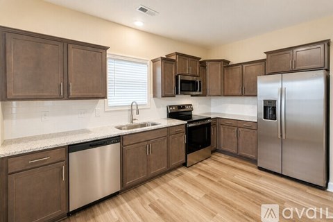 A kitchen with wooden cabinets and stainless steel appliances.