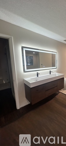 A bathroom vanity with a mirror above the sink.
