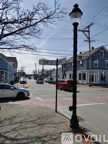 A street view of Elm Street with cars parked on the side of the road.