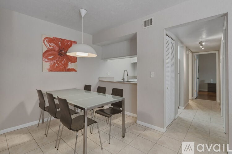 A dining room with a table and chairs.