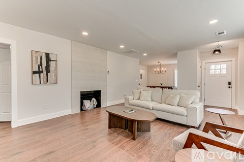 A living room with a white couch and a coffee table.