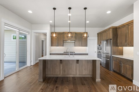 A modern kitchen with wooden cabinets and a white island.