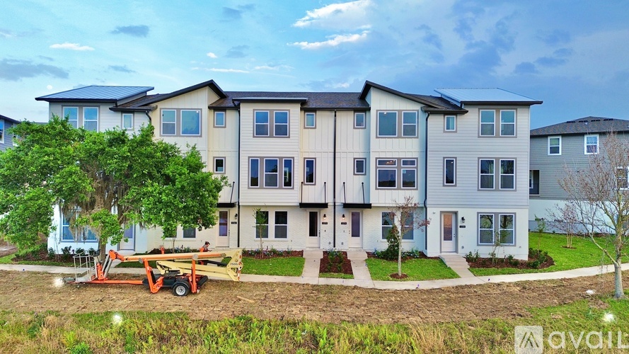 A large, multi-story building with a playground in front is available for rent.