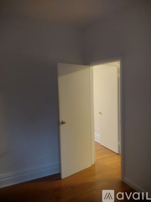 A white door is open to a hallway.