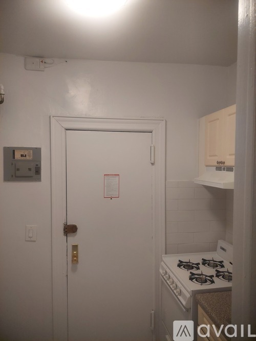 A white door with a red sign on it.