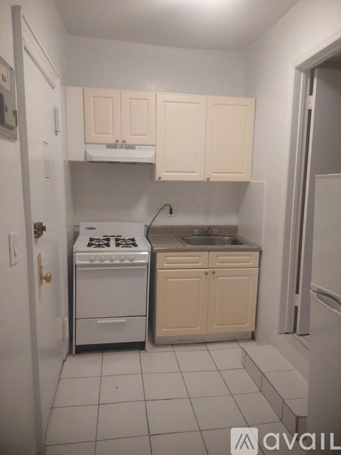 A kitchen with white appliances and cabinets.