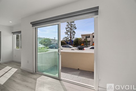 A modern interior space with a sliding glass door leading to an outdoor area.