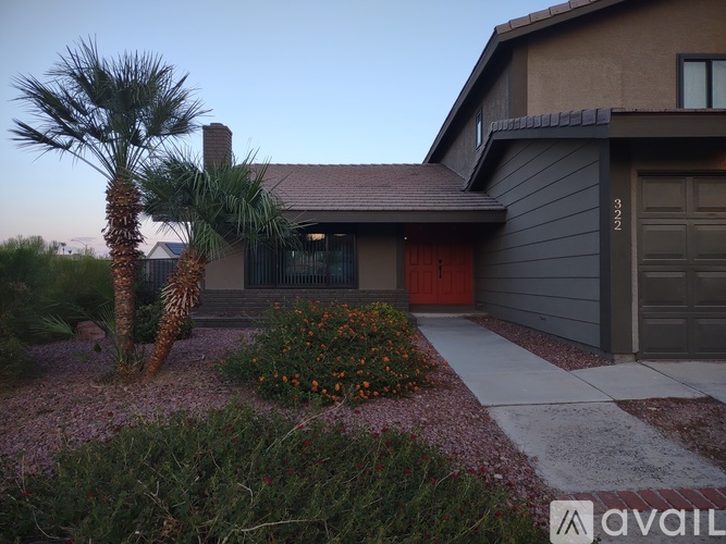 A house with a red door and a palm tree in front.