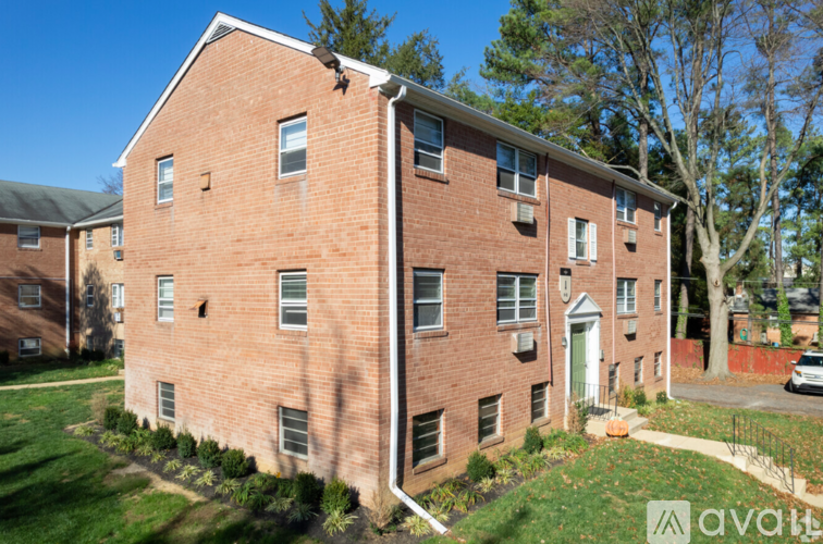 A brick building with a green lawn in front.