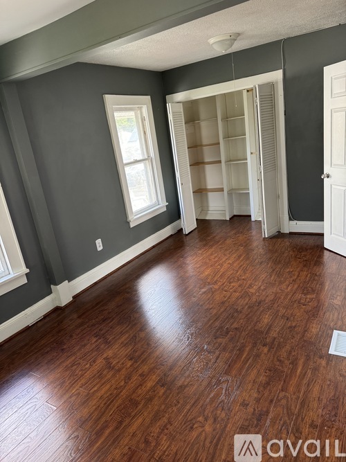 A room with grey walls and wooden flooring.