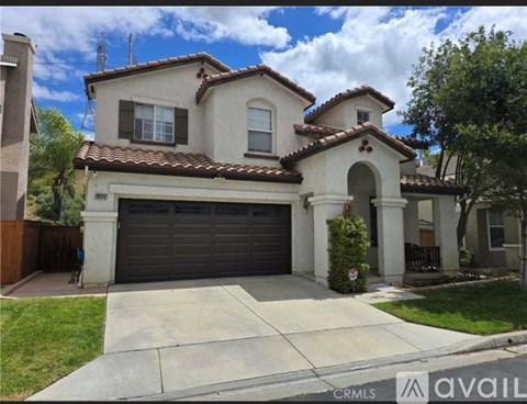 A house with a garage is for sale.