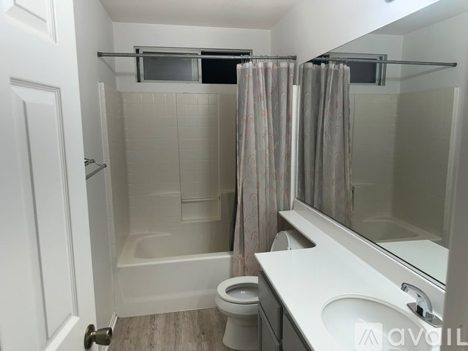 A bathroom with a toilet, sink, and bathtub.