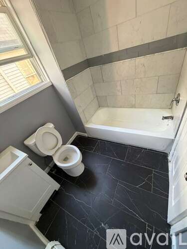 A bathroom with a toilet and a bathtub.