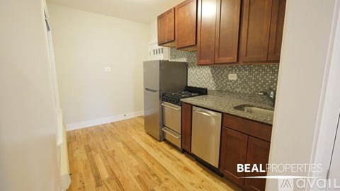A kitchen with wooden cabinets and a black stove top oven.
