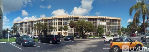 A large building with a parking lot in front of it.