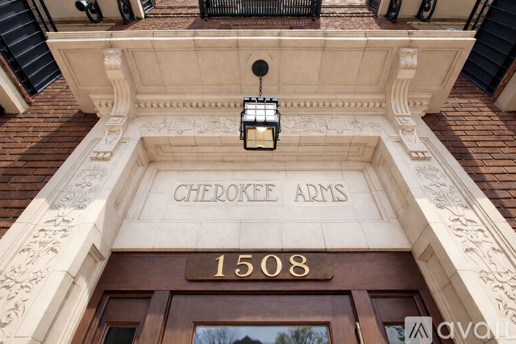 The front of a building with the name Cherokee Arms on it.