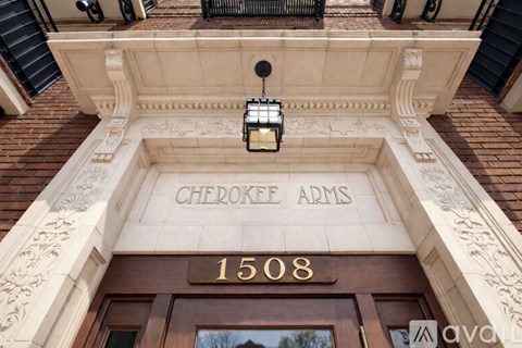 The front of a building with the name Cherokee Arms on it.