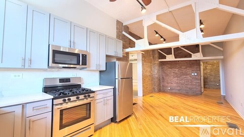 A kitchen with a stove, oven, and refrigerator is available for rent.