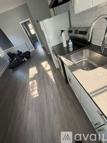 A kitchen with a sink and a counter.