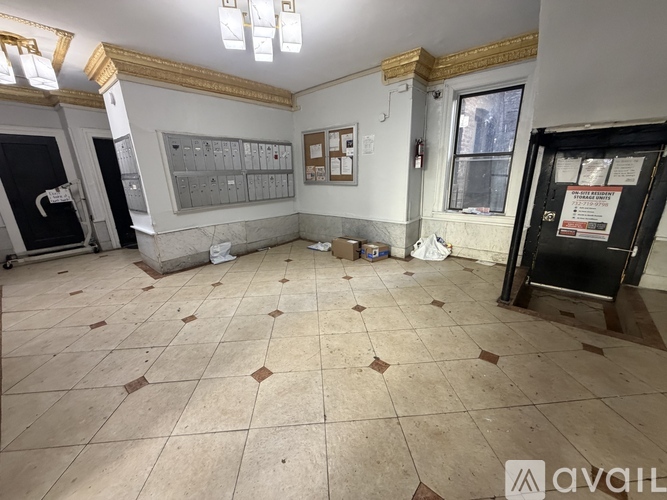 A room with tiled flooring and a wall of electrical switches.