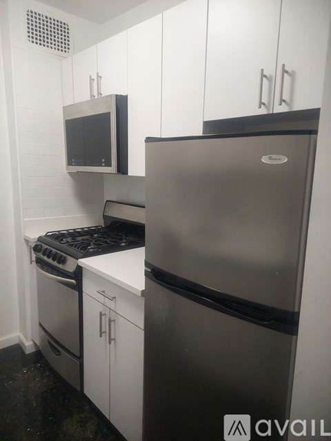 A kitchen with a stove, oven, and refrigerator.