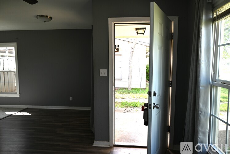 A room with a door leading outside.
