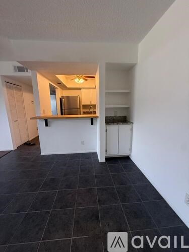 A kitchen area with a counter and cabinets.