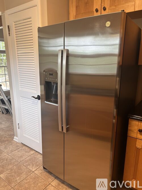 A stainless steel refrigerator with a water and ice dispenser in the door.