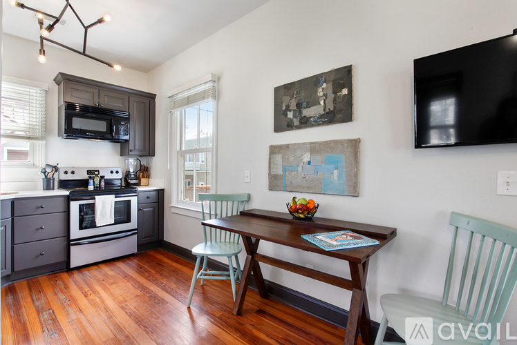 A kitchen with a wooden table and chairs.