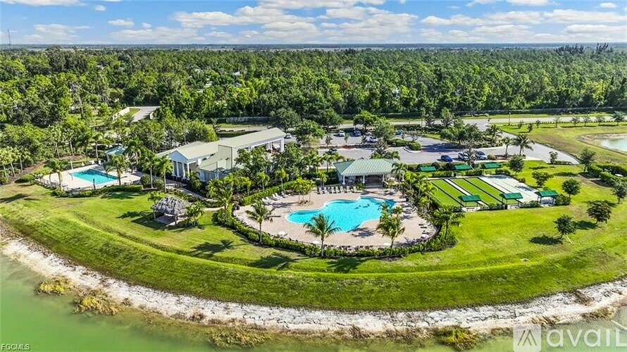 A bird's eye view of a resort with a swimming pool and a beach.