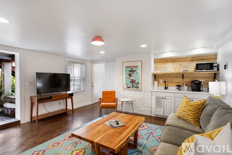 A living room with a wooden coffee table and a grey couch.