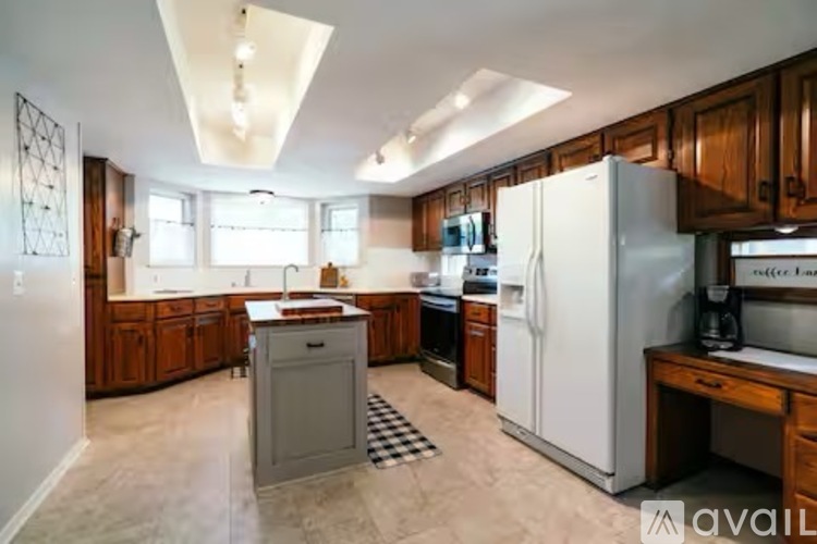 A kitchen with wooden cabinets and a white refrigerator.
