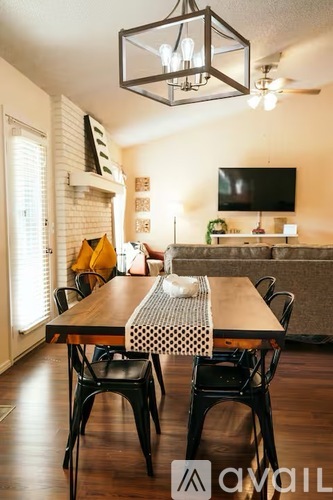 A dining room with a wooden table and chairs.