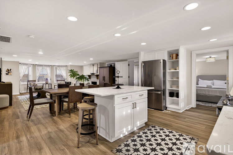 A modern kitchen with white cabinets and a central island.