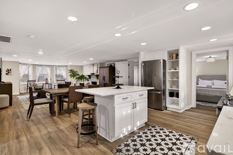A modern kitchen with white cabinets and a central island.