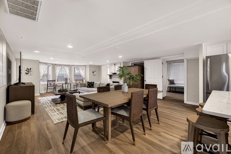 A modern dining room with a wooden table and chairs.