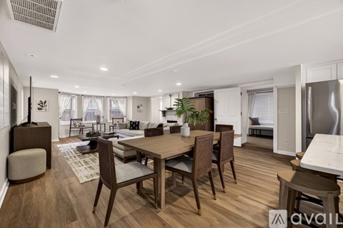 A modern dining room with a wooden table and chairs.