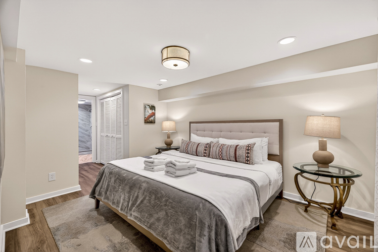 A bedroom with a large bed and a glass table.