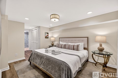 A bedroom with a large bed and a glass table.