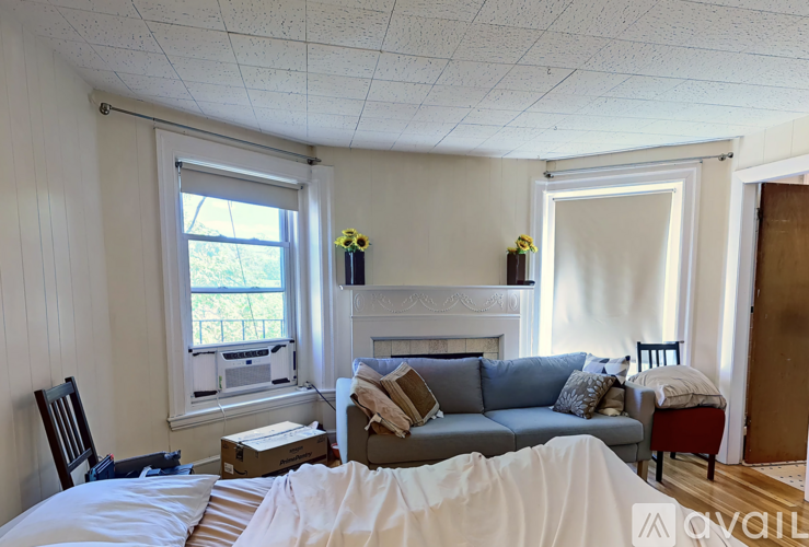 A living room with a couch, chair, and window.
