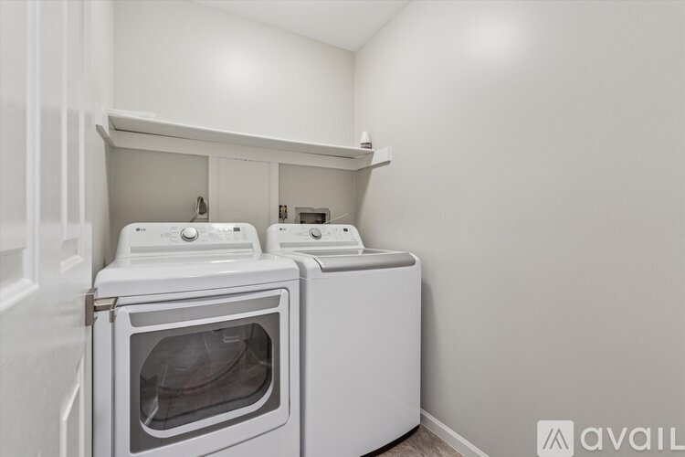 A white washing machine and dryer in a laundry room.