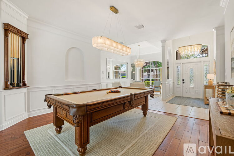 A pool table is in the middle of a room with a white background.