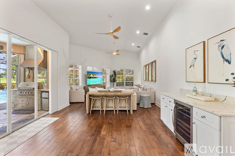 A kitchen with a table and chairs in the middle of the room.